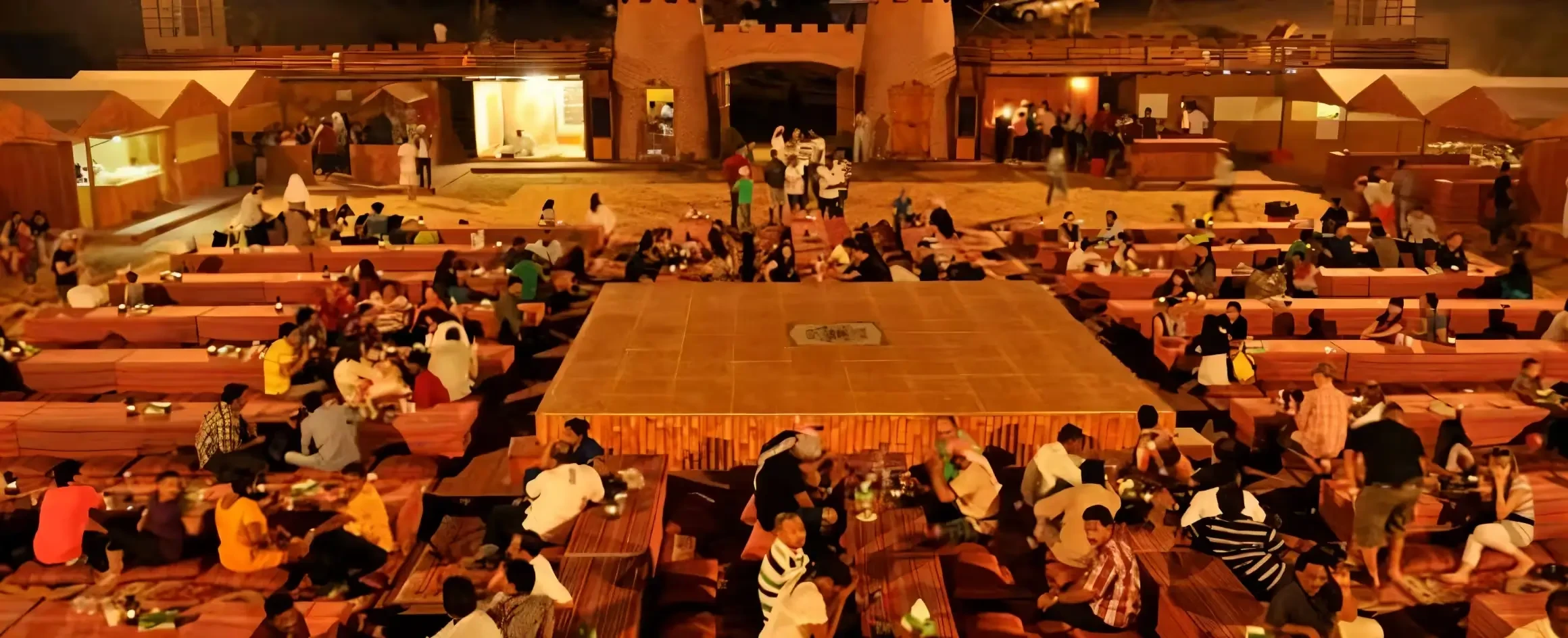 Large group enjoying dinner under stars on premium desert safari Dubai
