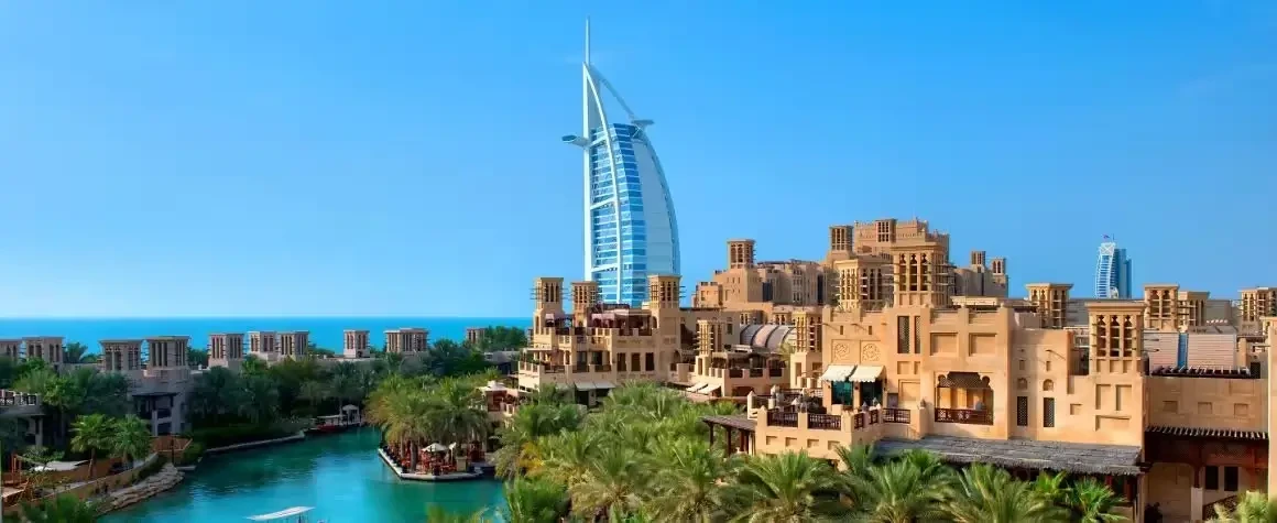 Wide view of Burj Al Arab with ocean backdrop during Dubai tour