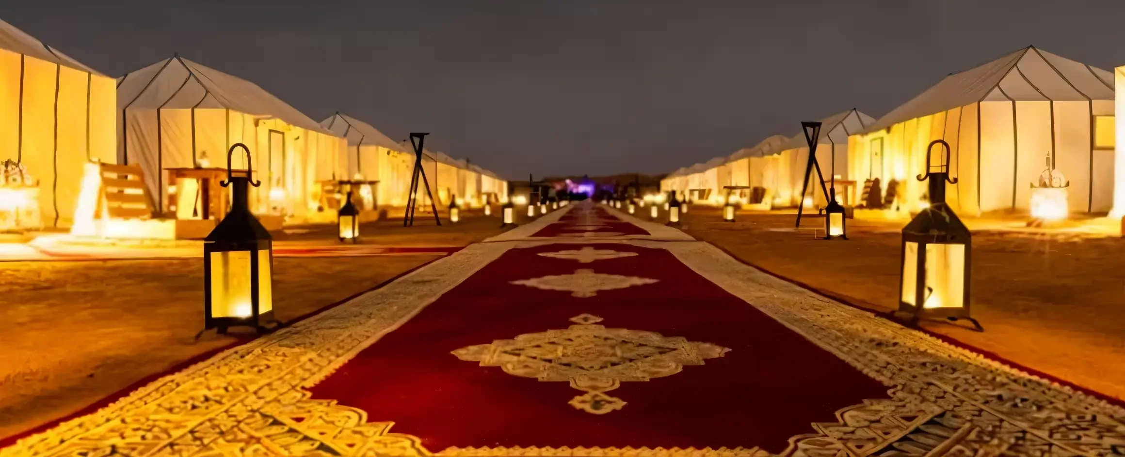 Night view in Dubai desert with elegant carpet setup and ambient lighting