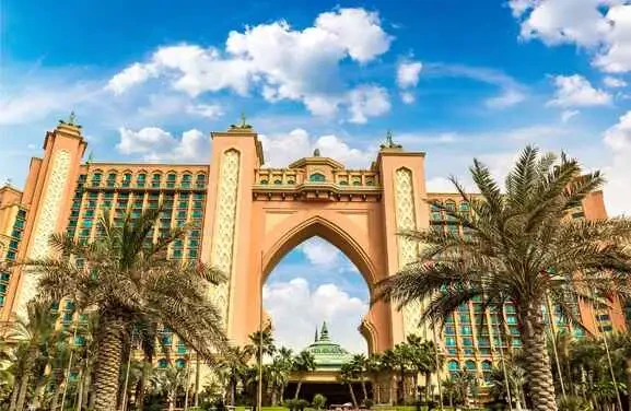 Iconic Atlantis Hotel in Dubai, showcasing its unique architecture and luxurious resort features against a clear blue sky.