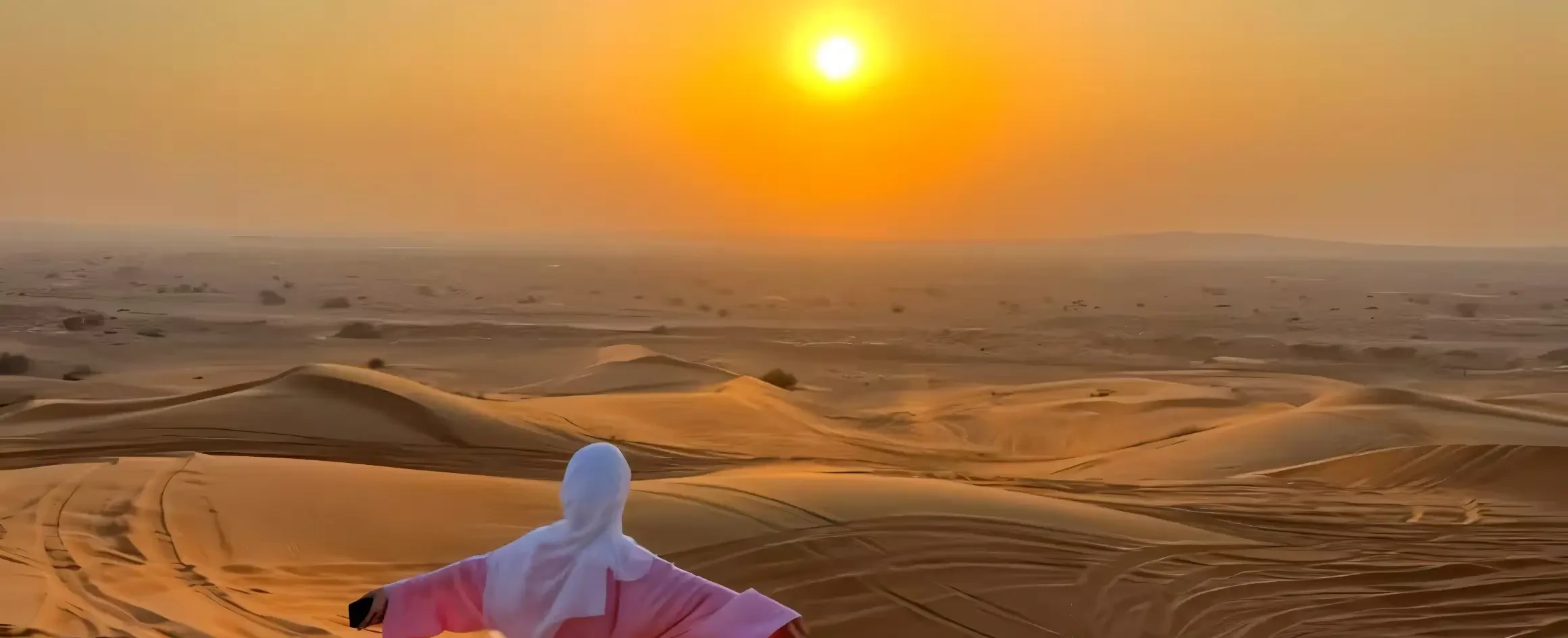 Girl admiring Dubai desert sunset during premium safari adventure