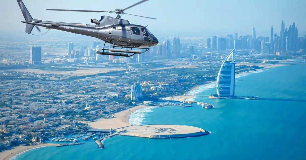 Helicopter tour over Dubai, featuring a panoramic view of the city skyline and the Burj Al Arab landmark.