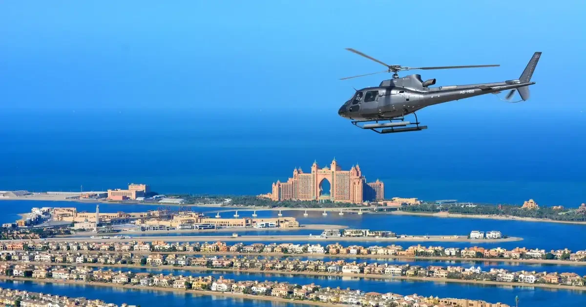A helicopter flying over a cityscape with a large body of water, showcasing a Dubai helicopter tour experience.