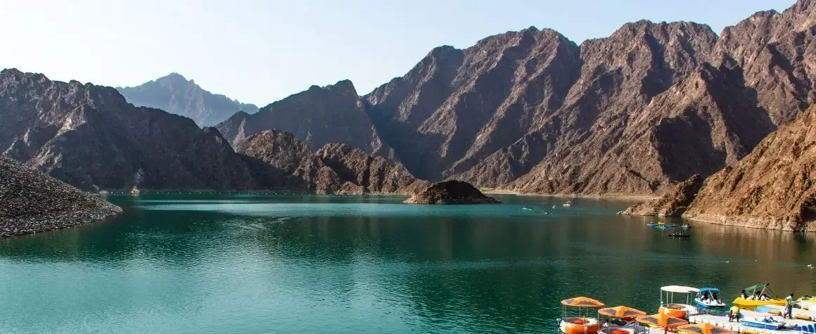 Scenic mountain landscape with a lake in the middle on Hatta Dubai Tour