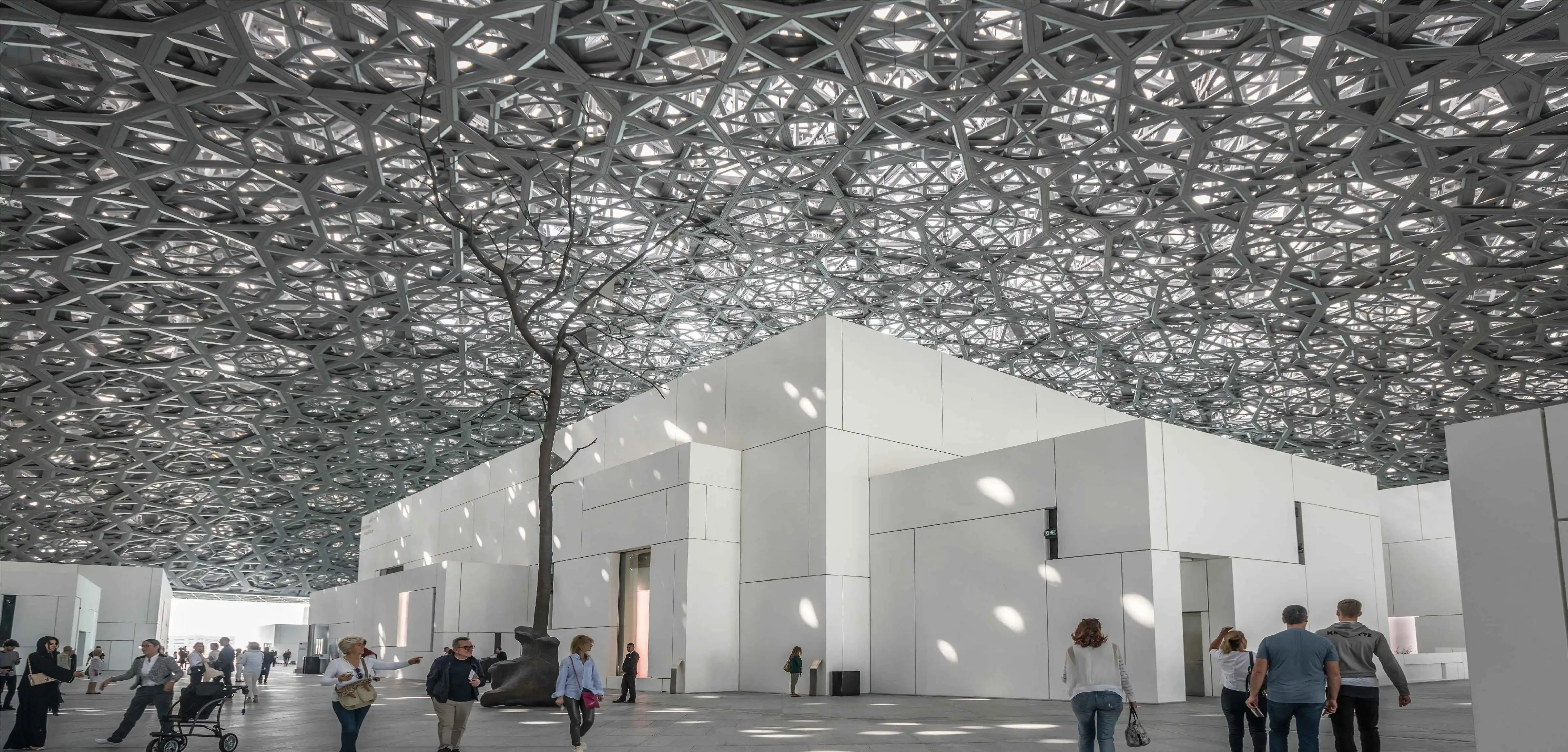 Interior of a museum featuring a photogenic dome with geometric shapes, creating a stunning "rain of light" effect.