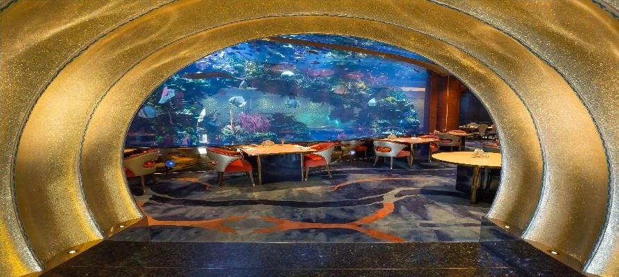 Dining area of the aquarium restaurant at the Marriott hotel in Dubai, showcasing a large aquarium for a unique ambiance.