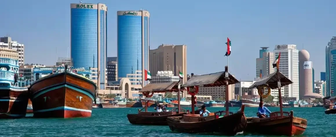View of Rolex Twin Towers and boats along Dubai Creek
