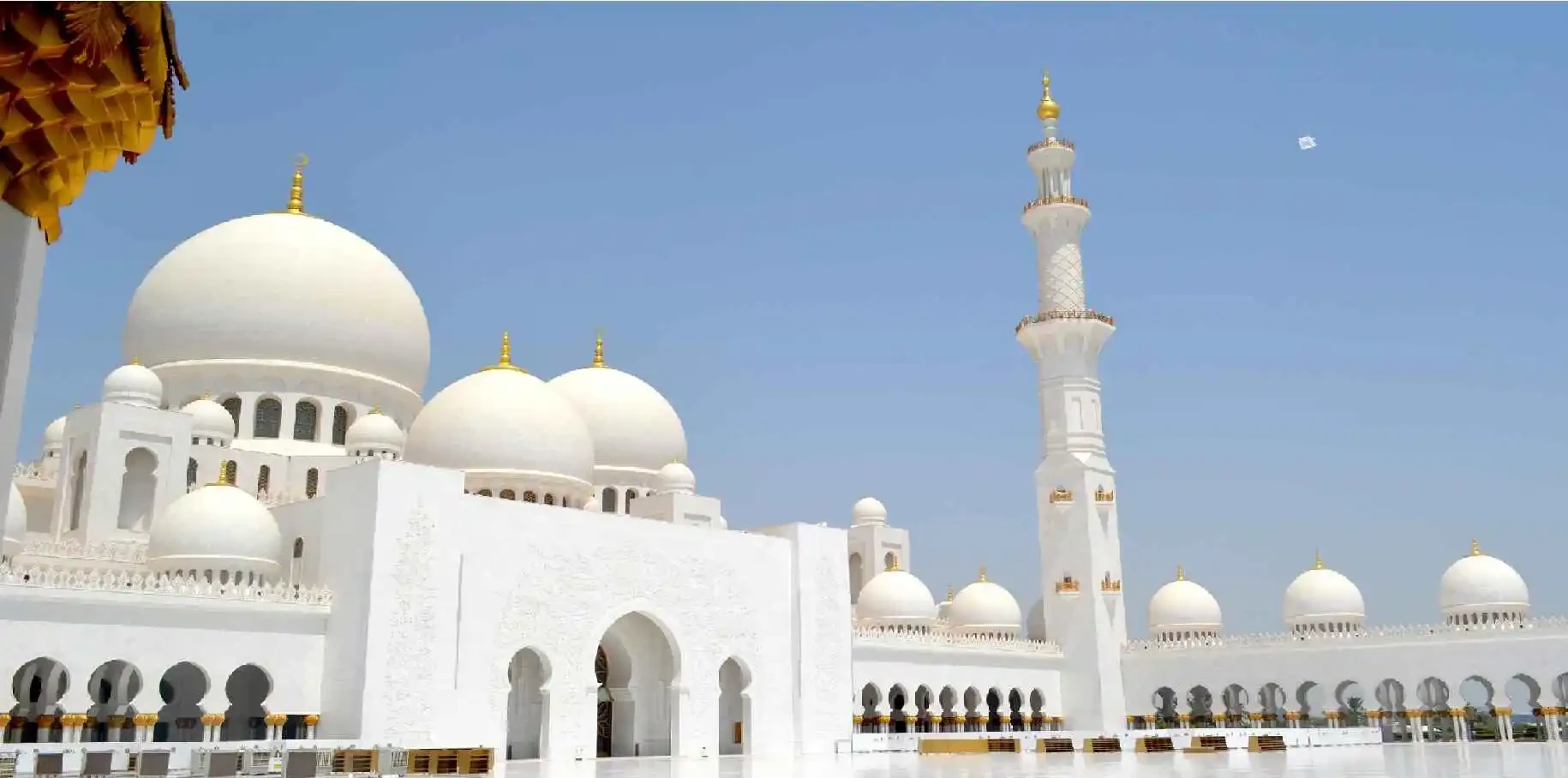 Sheikh Zayed Grand Mosque in Abu Dhabi, showcasing its stunning white domes and intricate architectural details.