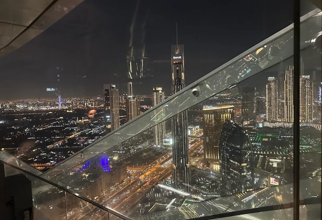 Breathtaking night view of the Burj Khalifa and Downtown Dubai skyline from the glass floor of the Sky View Observatory.