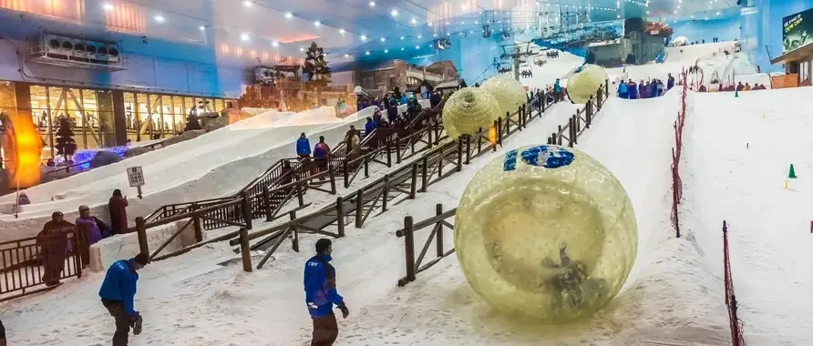 People stroll through a snow park in Dubai, enjoying the winter-themed attractions and activities.