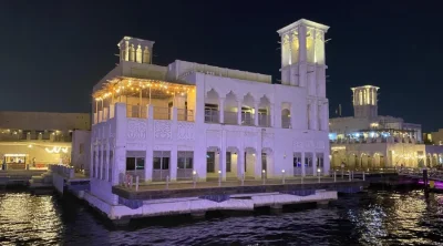 Traditional architecture along Dubai Creek waterfront at night