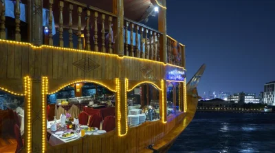 Dubai dhow cruise dinner boat illuminated at night