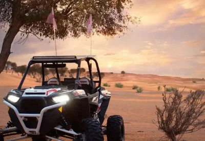 A UTV stands still in the desert at sunset, highlighting the perfect setting for an exhilarating buggy ride.